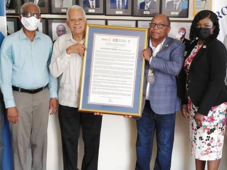 Credit: Contributed Vocational award: Alister Cooke (second left), former general manager of the Shipping Association of Jamaica and Kingston Wharves Limited, accepts a citation for vocational service from Alva Wood (second right), president of the Rotary Club of Kingston. Al