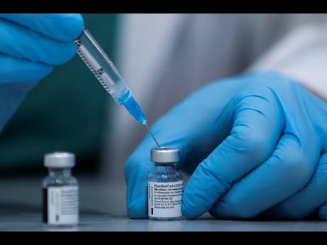 A healthcare professional prepares a Pfizer-BioNTech COVID-19 vaccine at Sheba Tel Hashomer Hospital in Ramat Gan, Israel.  
