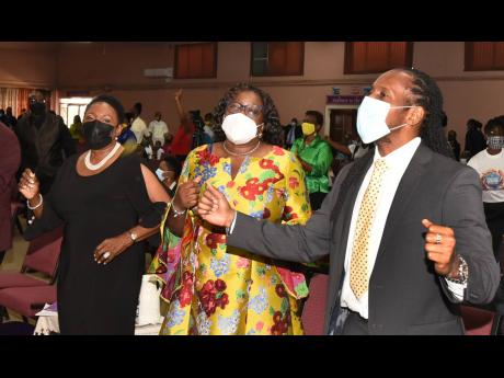 Minister of Culture, Gender, Entertainment and Sport Olivia ‘Babsy’ Grange (left), takes part in a church service for Reggae Month on Sunday at the Fellowship Tabernacle, in Kingston. Also participating are Alando Terrelonge (right), minister of state 