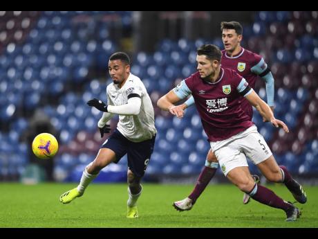 Credit: AP Manchester City’s Gabriel Jesus (left) and Burnley’s James Tarkowski challenge for the ball during the English Premier League match between Burnley and Manchester City at Turf Moor stadium in Burnley, England, yesterday. City won 2-0.