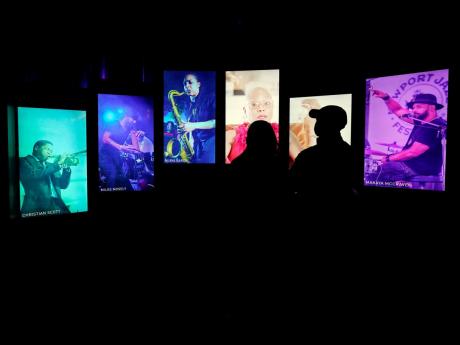 Visitors watch an exhibit at the National Museum of African American Music.