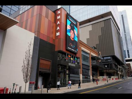 People walk to the entrance of the National Museum of African American Music, in Nashville, Tenn. Unlike other museums that focus on a genre or label, this new museum is the first to span multiple genres including gospel, blues, jazz, R&B and hip hop. 