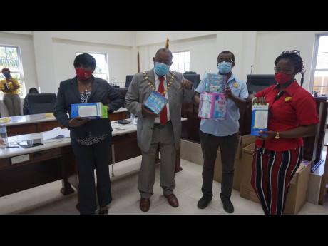 From left: Marvaly Pitter, chief executive officer at the Westmoreland Municipal Corporation; Bertel Moore, Mayor of Savanna-la-Mar; Glenford Daley, managing director of Daley’s Mini Mart and Laur-Ann Daley, marketing manager at Daley’s Mini Mart pos