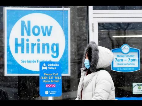 Credit: AP
In this February 6, 2021 file photo, a woman walks past a “Now Hiring” sign displayed at a CD One Price Cleaners in Schaumburg, Illinois. In a stark sign of the economic inequality that has marked the pandemic recession and recovery, Americans as a w