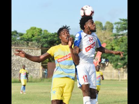 Portmore United's Tevin Shaw (right) heads the ball away while challenged by Waterhouse's Stephen Williams during their Jamaica Premier League match at the Spanish Town Prison Oval on Sunday, November 10, 2019.