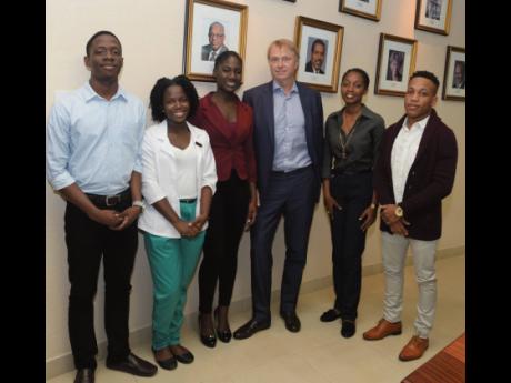 Wed Edens (third right), chairman and CEO of New Fortress Energy (NFE), stands with the first cohort of NFE’s tertiary scholarship recipients at The University of the West Indies. From left: Jordan Hayles (electrical engineering), Crystal Duncombe (medic