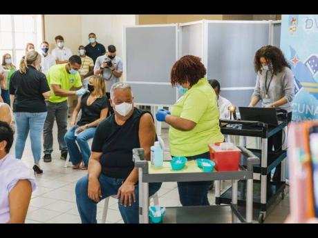 Credit: Arubans getting their jabs of the Pfizer COVID-19 vaccine.