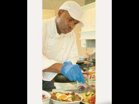 Chef Everton Smith puts the finishing touches to one of his delectable masterpieces.