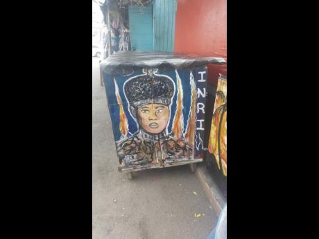 HRH enflamed painted on a roadside stall at Friendship Lane, Cross Roads.
