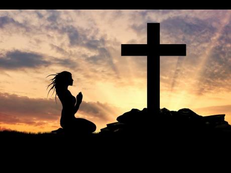Silhouette of a woman praying