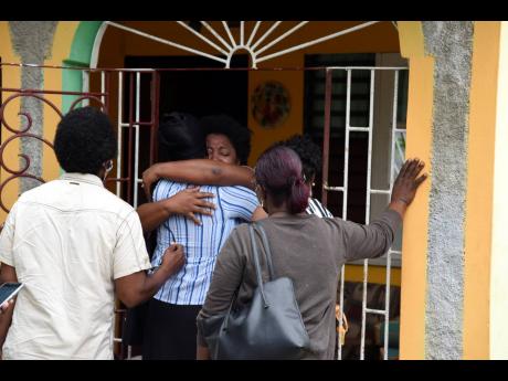 The family of 24-year-old Cody McLaughlin mourns his death at the family home in Duncans Pen, St Catherine. 