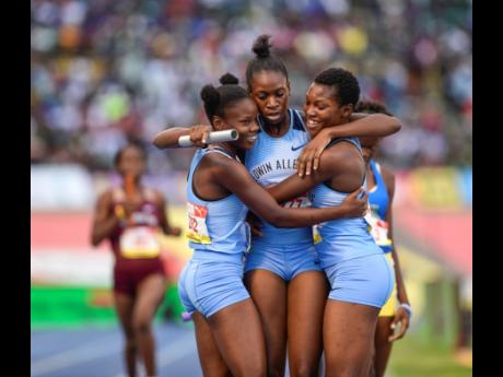Members of Edwin Allen High School’s girls’ 1600m sprint medley relay team celebrate their win at the ISSA/GraceKennedy Boys and Girls’ Athletics Championships at the National Stadium on Saturday, March 30, 2019.