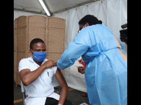 Thirty-one-year-old Jermaine Harris, pharmacist at the J&J Pharmacy, was the youngest person vaccinated at the Western Regional Health Authority yesterday.