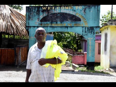 Noel Bennett, president of the community development committee in St Catherine, stands at the entrance to a walkway that takes visitors to the bottom of a natural bridge in Riversdale. He hopes to resurrect the stillborn dream of the bridge as an ecotouris
