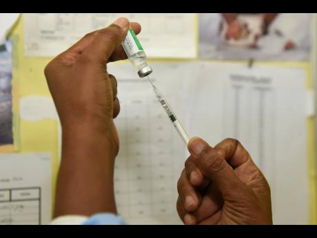A nurse preparing to administer a shot of the COVID-19 vaccine at the Windward Road Health Centre in Kingston on Monday.