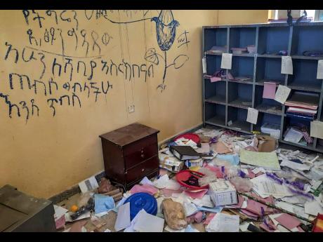 In this undated 2021 photo released by Medecins Sans Frontieres, anti-Tigrayan graffiti is scrawled on the walls of a vandalised room in a health centre in Debre Abay in the Tigray region of northern Ethiopia. Amid the unrest, rating agency Moody’s has d