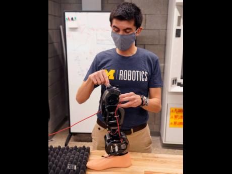 Edgar Bolivar describes the purpose of wearable robots at the University of Michigan’s Ford Motor Company Robotics Building on March 12, 2021 in Ann Arbor, Michigan.