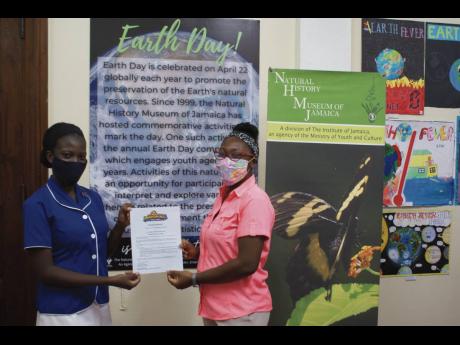 Immaculate Conception High School student Brianna Smith (left) receives her award for placing second place in the Literary Arts Category of the 2020 Earth Day competition.