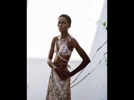 Saint International model Jannel Duncan is pictured in the new resort swimwear 2021 collection for American designer Jonathan Simkhai shot on location in Jamaica at Dunn’s River Falls and Fireflies Estate. Working as a legal administrative assistant in S