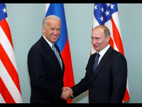 
In this March 10, 2011, file photo, then Vice-President Joe Biden (left) shakes hands with then Russian Prime Minister Vladimir Putin in Moscow, Russia.
