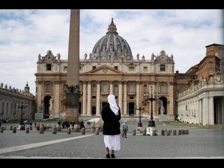 A nun stands in St Peter’s Square at the Vatican, Sunday, March 21.