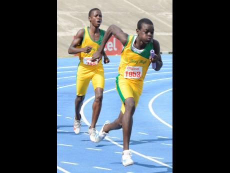 Omarion Dennis (right) sets off after receiving the baton from Demetry Goehagen and leading St Mary High School to a win in the Class Three boys 4x100m final at Eastern Athletics Championships on March 5, 2019 at the National Stadium.