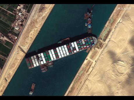 This satellite image from Maxar Technologies shows the cargo ship MV Ever Given stuck in the Suez Canal near Suez, Egypt, Saturday, March 27, 2021.   