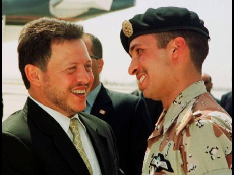 In this April 2, 2001 file photo, Jordan’s King Abdullah II (left) laughs with his half-brother Prince Hamzah shortly before the monarch embarked on a tour of the United States.