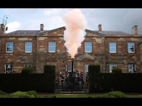 Members of the 206 Battery, 105th Regiment Royal Artillery fire a 41-round gun salute at Hillsborough Castle in Northern Ireland, Saturday, April 10, 2021. Britain’s Prince Philip died on Friday. 