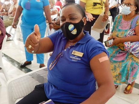 Collete Walker-Hopkins, assistant housekeeping manager at Bahia Principe Hotel in Runaway Bay, St Ann, gives a thumbs-up gesture after getting her COVID-19 vaccine. 