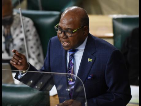 Credit: Ian Allen/Photographer Edmund Bartlett, minister of tourism, makes his Sectoral Debate presentation during the sitting of the House of Representatives in Parliament on Tuesday.