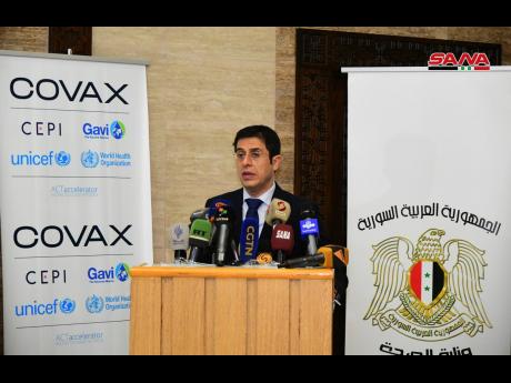 This photo released by the Syrian official news agency SANA, shows Syria’s Health Minister Hassan Ghabbash, during a press conference where he announced receiving the first batch of AstraZeneca COVID-19 vaccines, in Damascus, Syria yesterday.