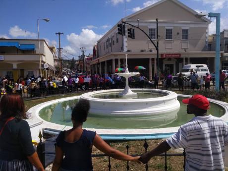 In this 2017 photo, citizens of St James create a human chain around the iconic water fountain in Sam Sharpe Square in solidarity to families who have lost loved ones to crime.