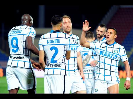 Inter Milan's Achraf Hakim (second from left) celebrates after scoring his side's second goal during the Italian Serie A match between Crotone and Inter Milan at the Ezio Scida Stadium in Crotone, Italy, yesterday. Inter won 2-0.