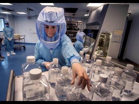 Credit: AP In this March 27, 2021 photo, a laboratory worker simulates the workflow in a cleanroom of the BioNTech Corona vaccine production in Marburg, Germany, during a media day.
