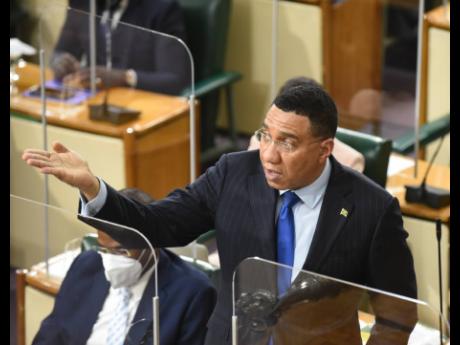 Prime Minister Andrew Holness gestures during his address to lawmakers in the House of Representatives on Tuesday. 