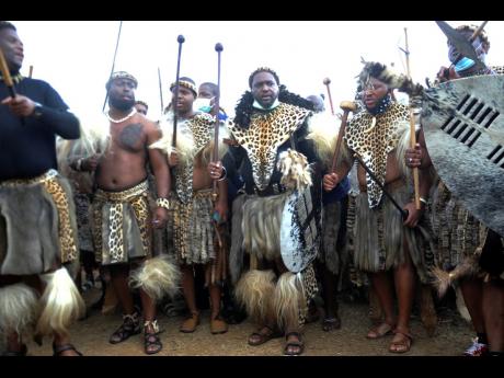 Credit: AP
Prince Misuzulu Zulu (centre), flanked by fellow warriors in traditional dress during a ceremony in Nongoma on Friday May 7, 2021. A new Zulu king in South Africa has been named amid scenes of chaos as other members of the royal family questioned Prince M