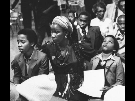 Rita Marley, widow of reggae superstar Bob Marley, and her two sons, Ziggy (left), and Stephen, attend Marley’s funeral in Kingston on May 21, 1981. 