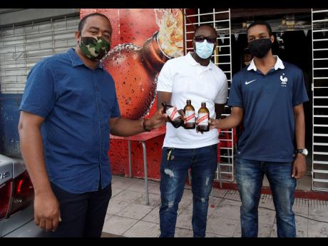 Credit: Nicholas Nunes/Photographer From left: Royan Prince, Kevin Haase and Lancelot Williams enjoy the end of a hectic workweek with a cold beer.