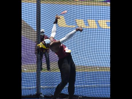 Credit: Kenyon Hemans Holmwood Technical’s Cedricka Williams on her way to setting a new record of 47.04m in the Girls Class Two discus event at ISSA/GraceKennedy Boys and Girls’ Athletics Championships at the National Stadium yesterday.