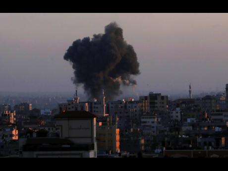 Smoke rises following Israeli airstrikes in Gaza City, yesterday.