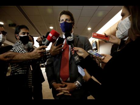 
Brazil’s Environment Minister Ricardo Salles speaks with reporters in Brasilia, Brazil, on Wednesday, May 19.