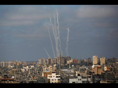 Rockets are launched from the Gaza Strip towards Israel, in Gaza City, yesterday.