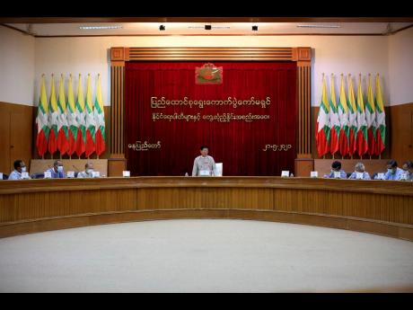 Union Election Commission Chairman Thein Soe (centre) speaks during a meeting with representatives of various political parties on Friday, May 21, in Naypyitaw, Myanmar. The head of Myanmar’s military-appointed state election commission said Friday his a