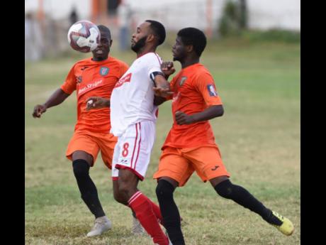 File
Fabion McCarthy (centre) of UWI FC in a keen tussle for the ball with Tivoli Gardens FC's Horatio Morgan (right) and Shavar Campbell (left) during a Premier League match on Sunday, January 19, 2020 at the Edward Edward Seaga Sports Complex.