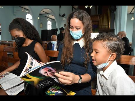 Elisabeth Mondon (centre), daughter-in-law of the late Ambassador Anthony Johnson, with her children Zoe Johnson (left) and Luc Johnson. 