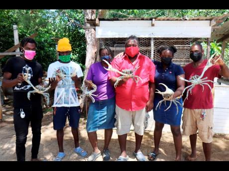 From left: Omar Stewart, Ferno Stewart, Rose-Marie Codner, Jermaine Morris, Regina Morris, Richard Williams on the crab farm in Rock, Trelawny,