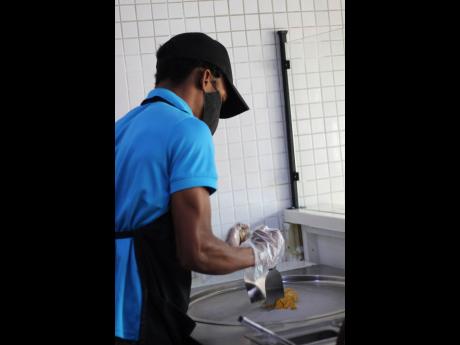 Tai Tai’s Kiwayne Bennett puts all his positive energy and strength into blending the mango and soursop.