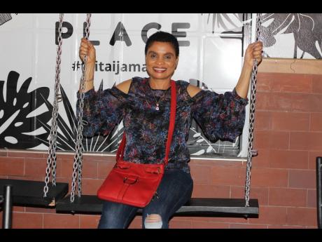 Celebrating her birthday, Tai Tai customer Joan Johnson enjoys the swings on the outside.
