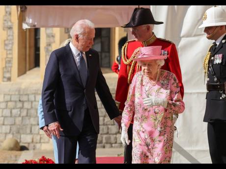 Britain’s Queen Elizabeth II walks with US President Joe Biden during his visit to Windsor Castle yesterday. 